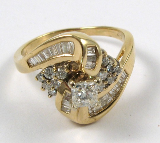 Appraisal: DIAMOND AND FOURTEEN KARAT GOLD RING centering a round brilliant-cut