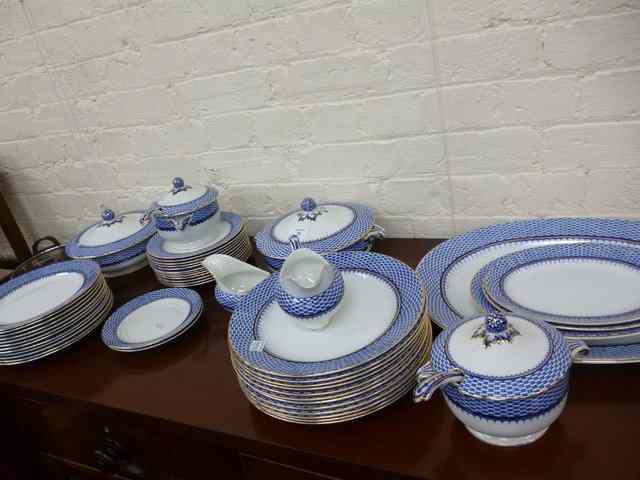 Appraisal: A ROYAL CAULDON PART DINNER SERVICE with blue and white