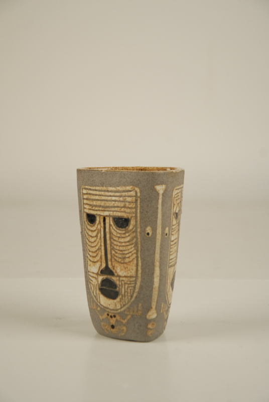 Appraisal: Three-sided Vase with Craved Tribal Faces signed Evelyn H