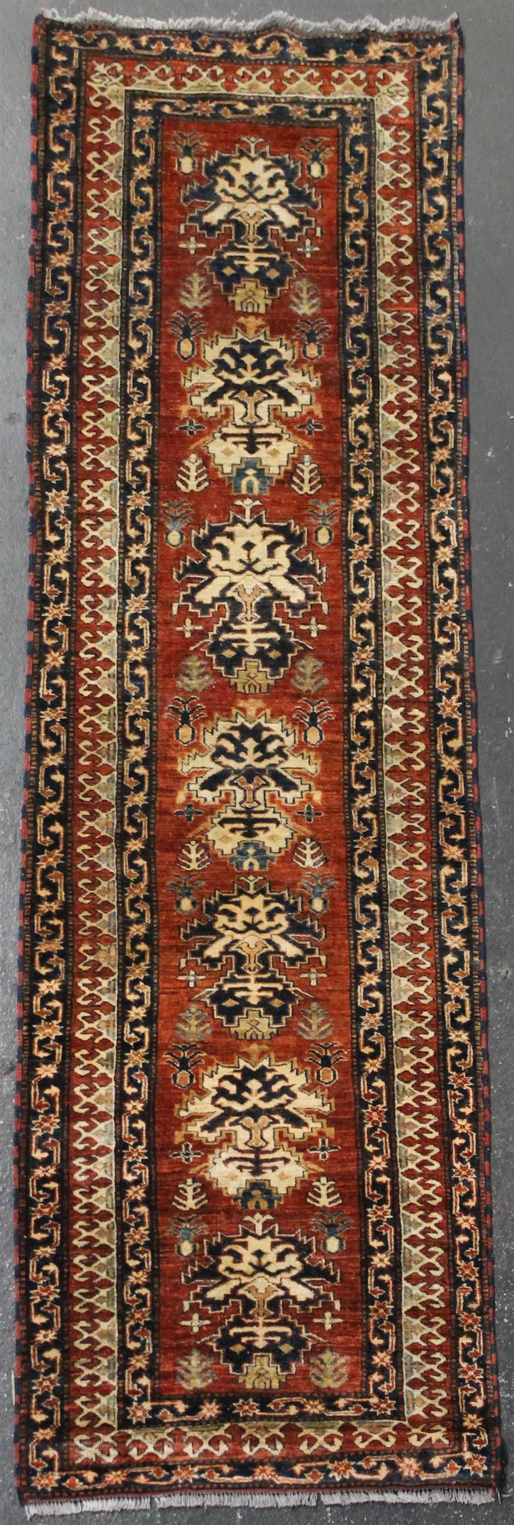 Appraisal: KAZAK WOOL RUNNER having a red field with blue taupe