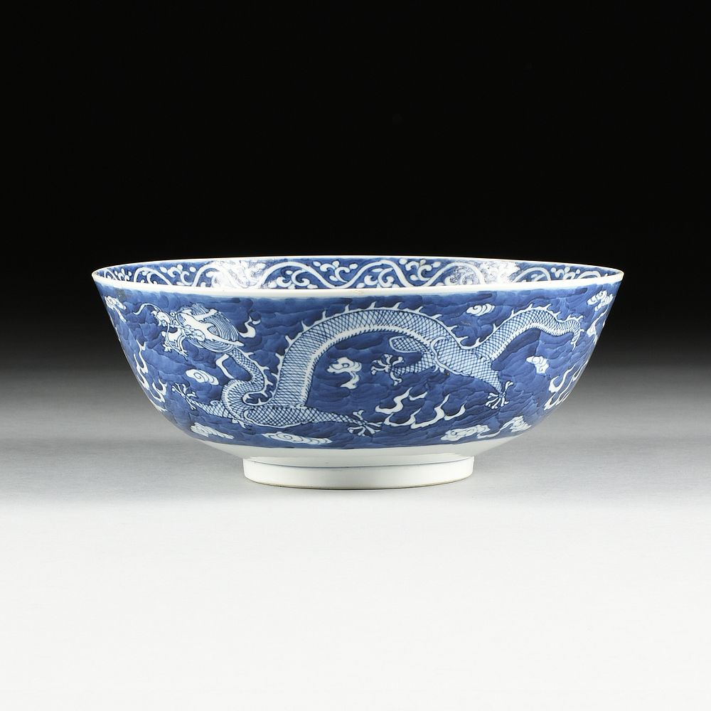 Appraisal: A CHINESE BLUE AND WHITE DRAGON AND CLOUD FOOTED BOWL