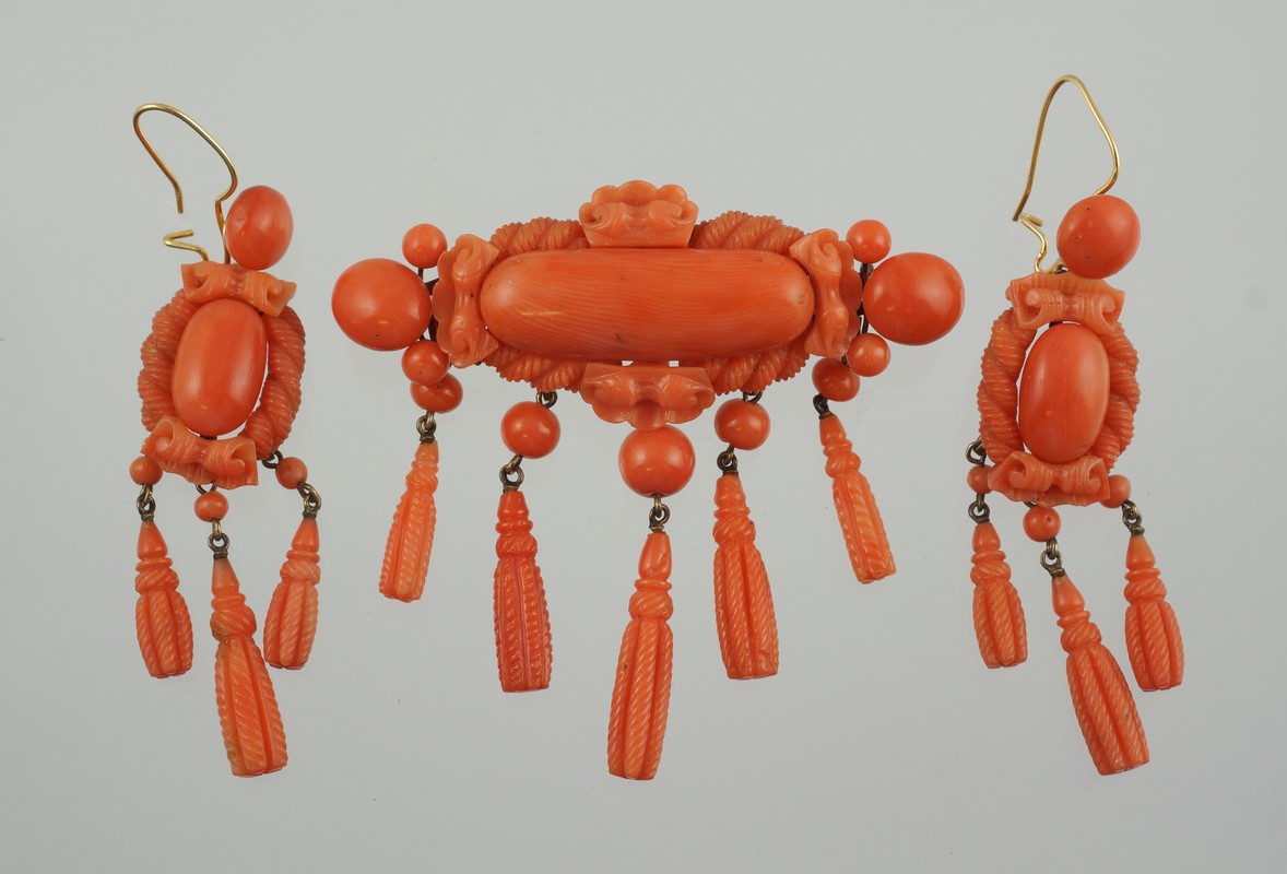 Appraisal: Carved coral pin with matching earrings YG wire mounts tests