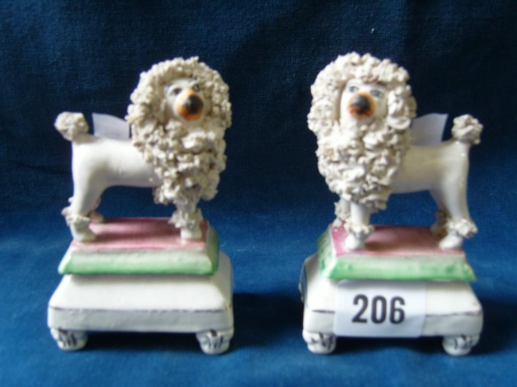 Appraisal: A pair of th century Staffordshire models of standing poodles