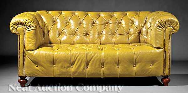 Appraisal: An Antique English Chesterfield Leather Settee padded scroll arms turned