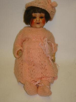 Appraisal: A German sprayed bisque head doll with blue sleeping eyes