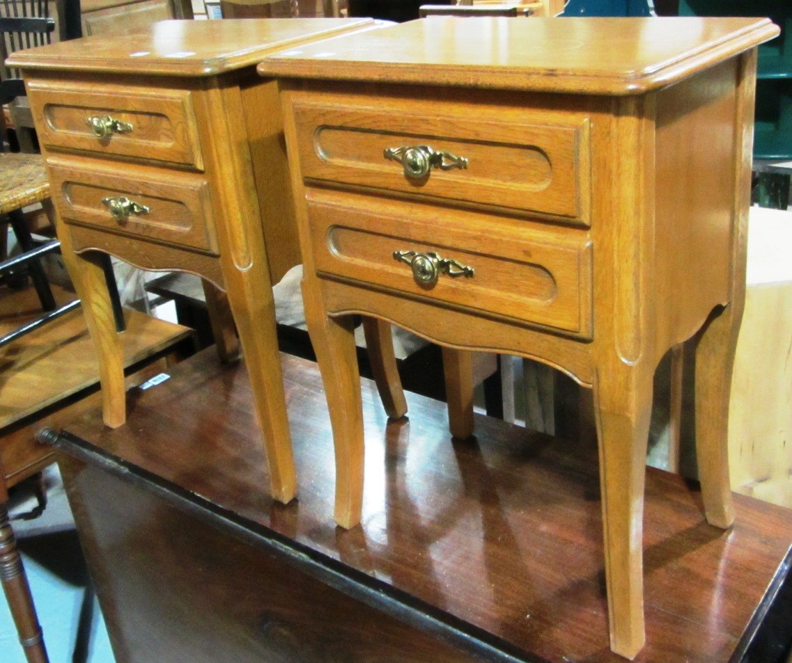 Appraisal: A pair of th century oak two drawer bedside tables