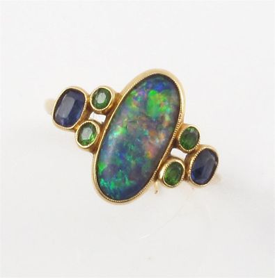 Appraisal: An opal set gold ring with two demantoid garnets and