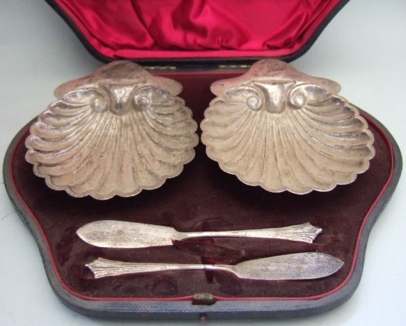 Appraisal: Two silver butter shell dishes each raised on three spherical