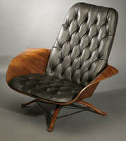 Appraisal: A Plycraft walnut-veneered lounge chair A Plycraft walnut-veneered lounge chair