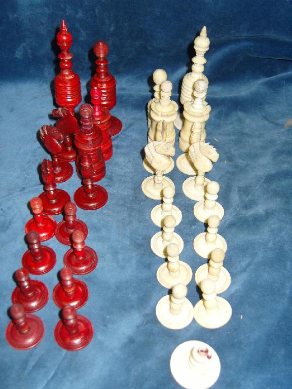 Appraisal: A set of chessmen with stained red and white finish