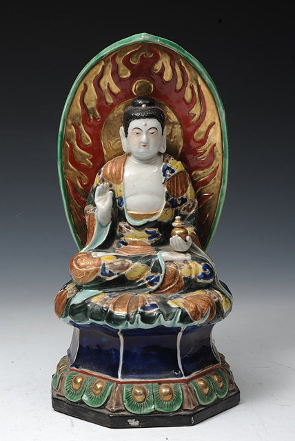 Appraisal: A JAPANESE POLYCHROME PORCELAIN MODEL OF A SEATED BUDDHA on