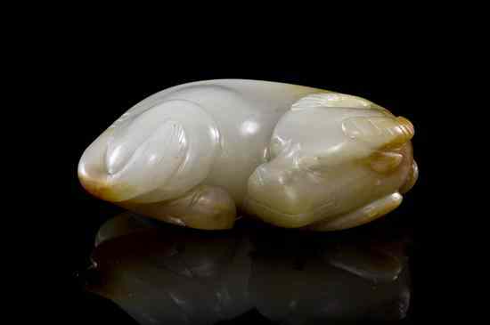 Appraisal: A Carved Khotan Jade Pebble Carving of celadon colored stone