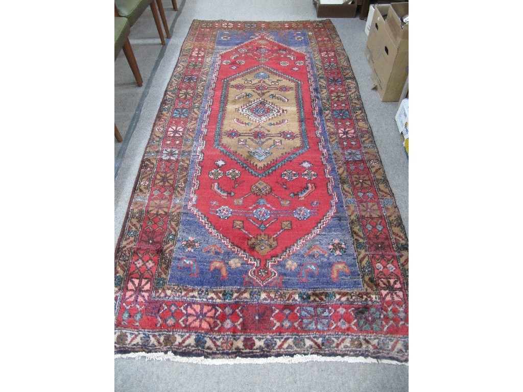 Appraisal: Iranian floor rug on a red blue and cream ground