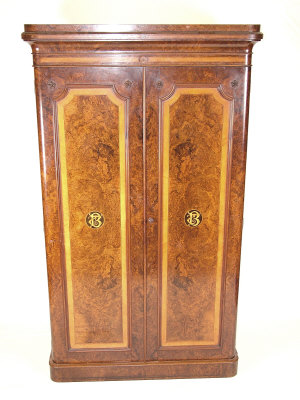 Appraisal: A Victorian burr walnut wardrobe the bolection moulded inlaid cornice