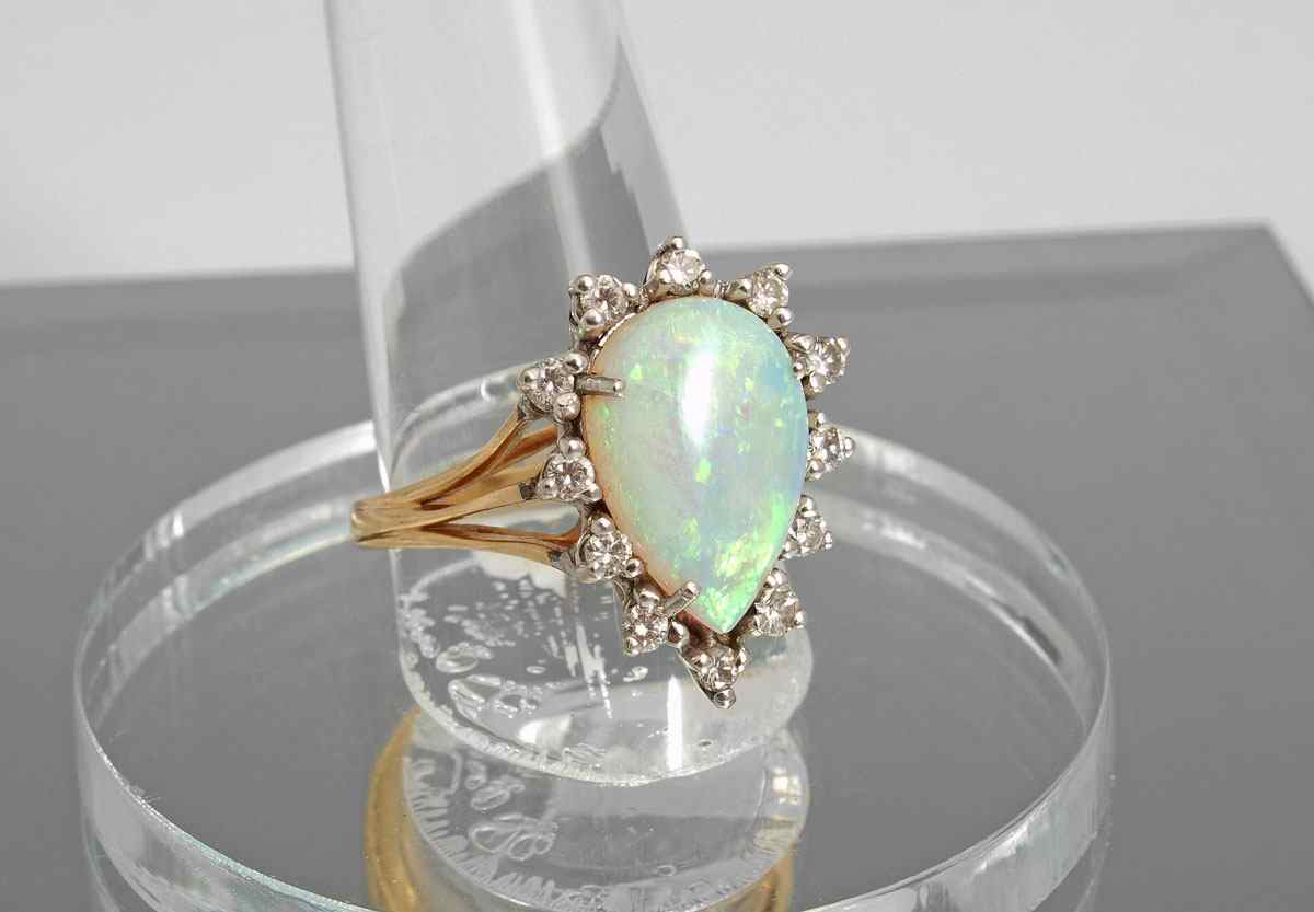 Appraisal: OPAL AND DIAMOND RING K yellow gold ring contains round