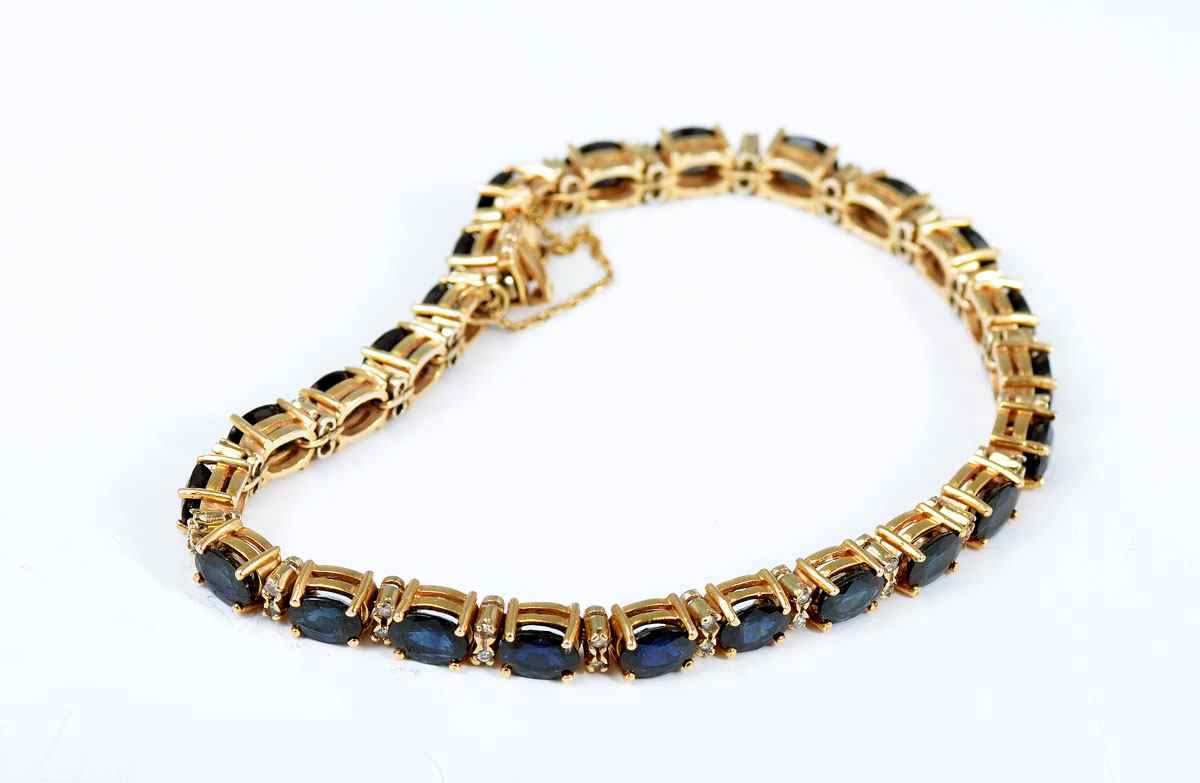 Appraisal: K SAPPHIRE DIAMOND BRACELET K yellow gold bracelet contains oval