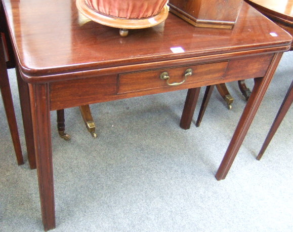 Appraisal: A George II mahogany fold-over tea table the rectangular top