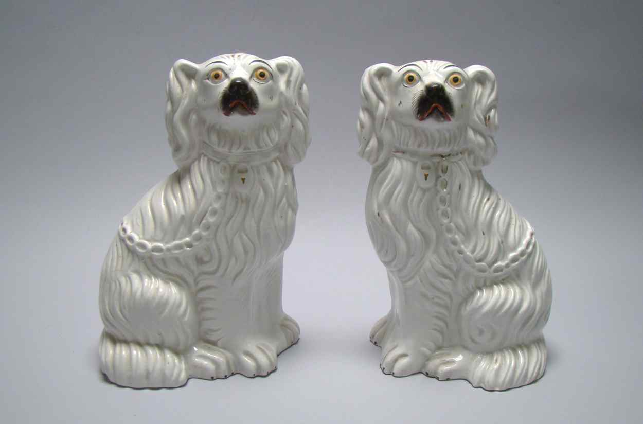 Appraisal: PAIR OF ENGLISH STAFFORDSHIRE POTTERY SPANIELS Circa With traces of