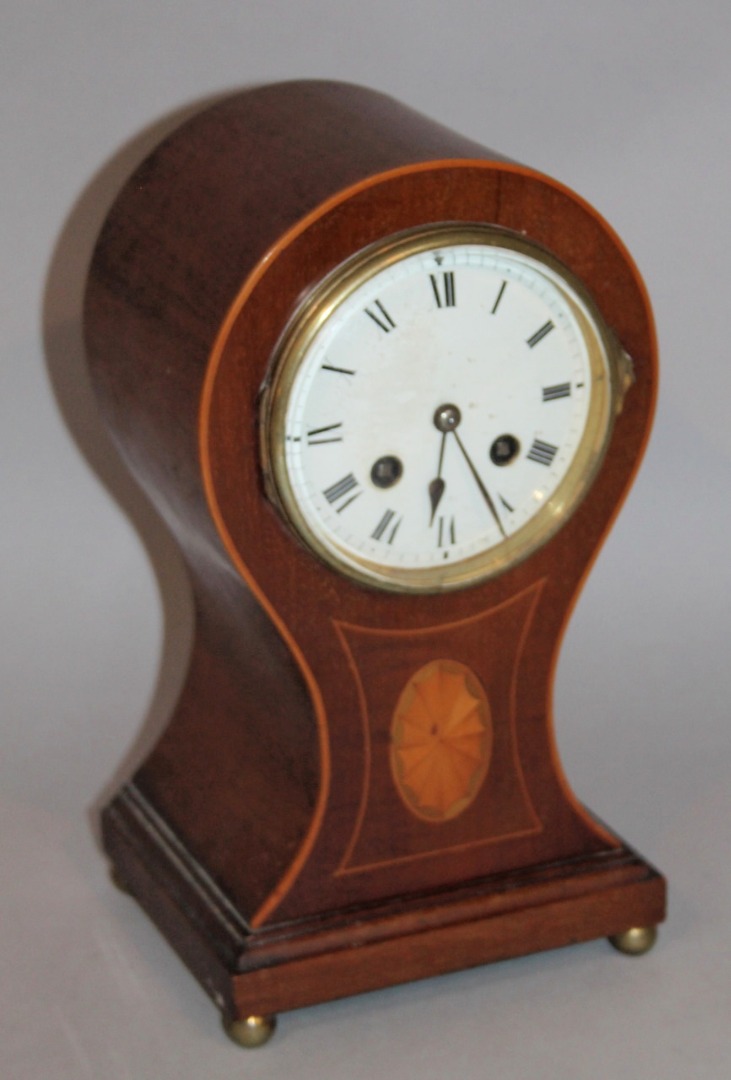 Appraisal: An Edwardian mahogany and boxwood strung balloon clock the cm