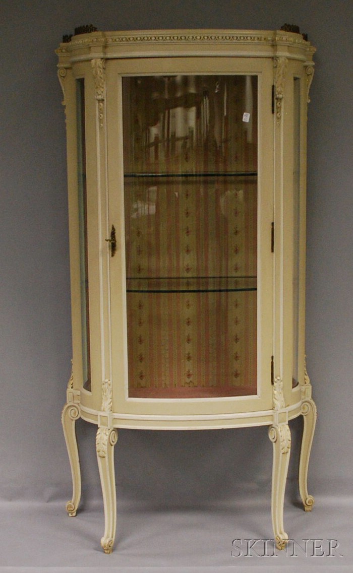 Appraisal: White-painted Louis XV Style Carved Wooden Swell-front Vitrine the interior