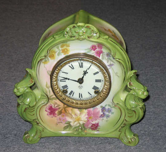 Appraisal: ROYAL BONN PORCELAIN SHELF CLOCK Ansonia enamel face hand painted