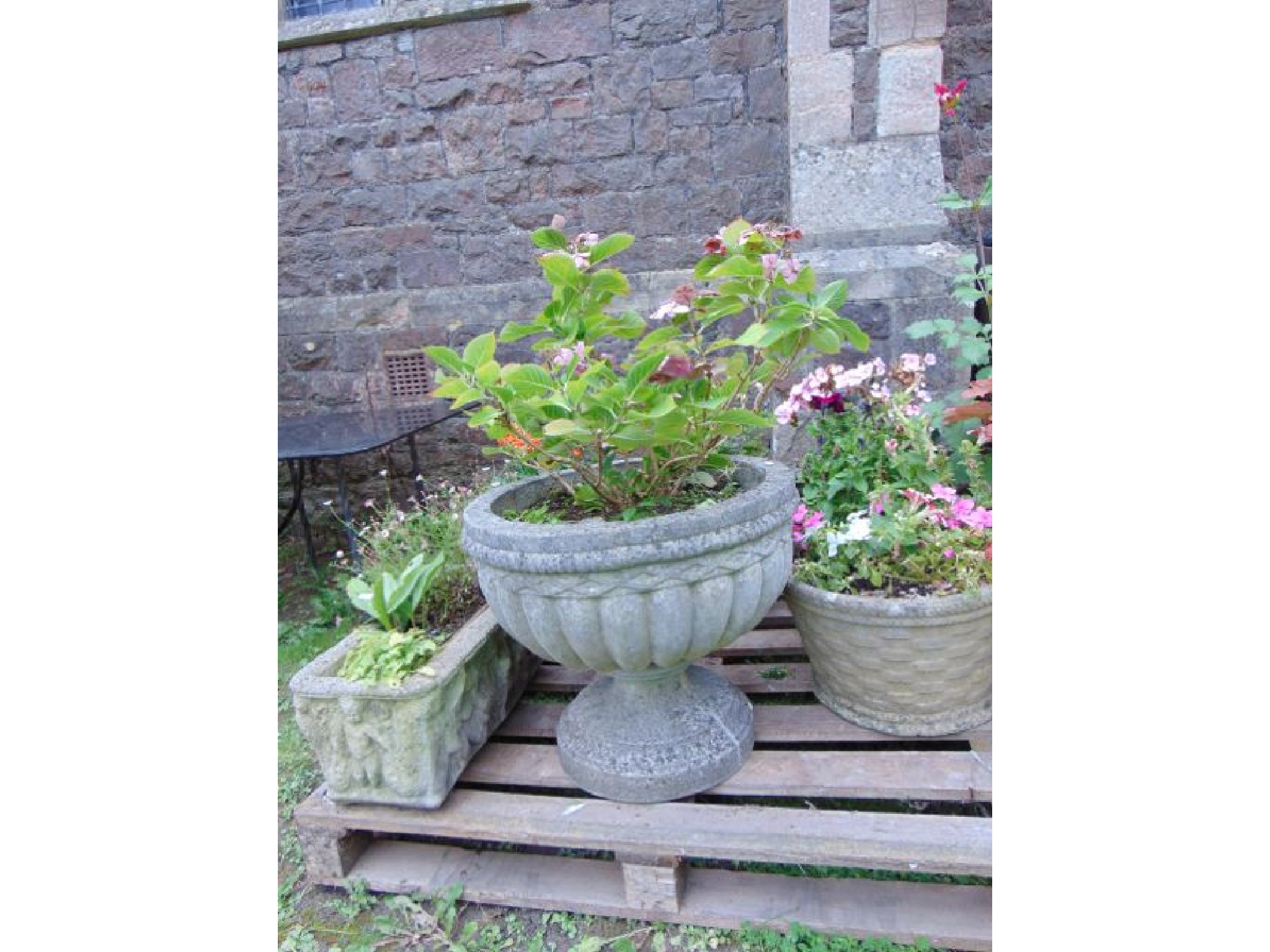 Appraisal: Six weathered cast composition stone garden planters of varying design