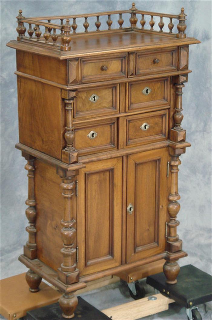 Appraisal: Carved walnut Continental side cabinet with a spindled gallery base