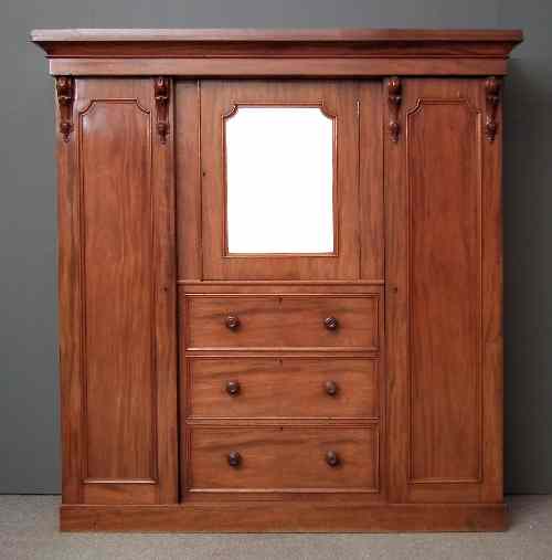 Appraisal: A Victorian mahogany fitted wardrobe with moulded cornice and carved