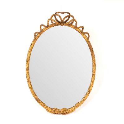 Appraisal: An oval gilt framed mirror with ribbon-tie to crest the