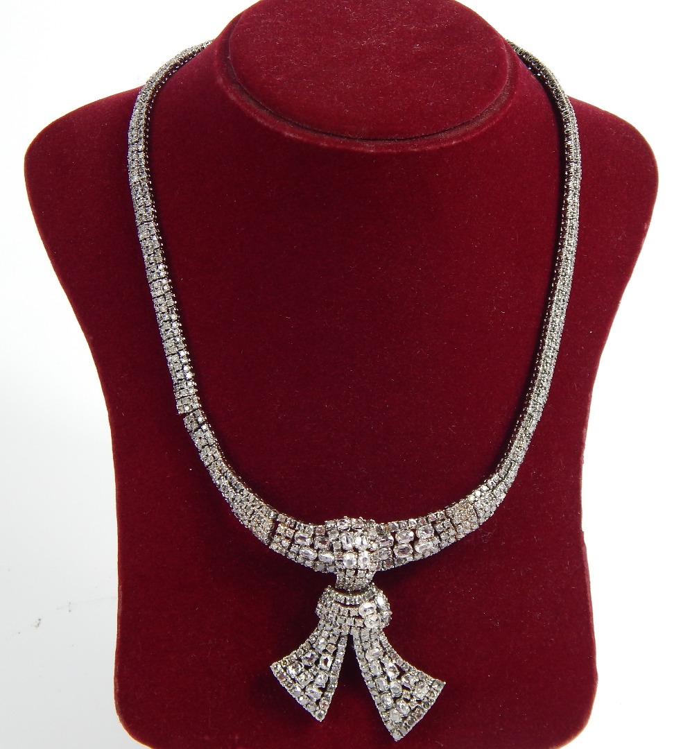 Appraisal: An ct white gold and diamond necklace of tied knot