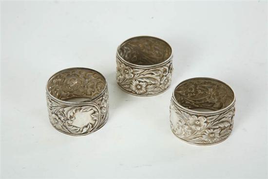 Appraisal: THREE KIRK STERLING NAPKIN RINGS Floral repoussee decoration One is