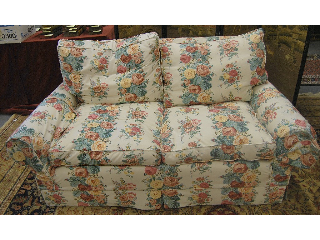 Appraisal: A pair of floral print feather filled cottage sofas a