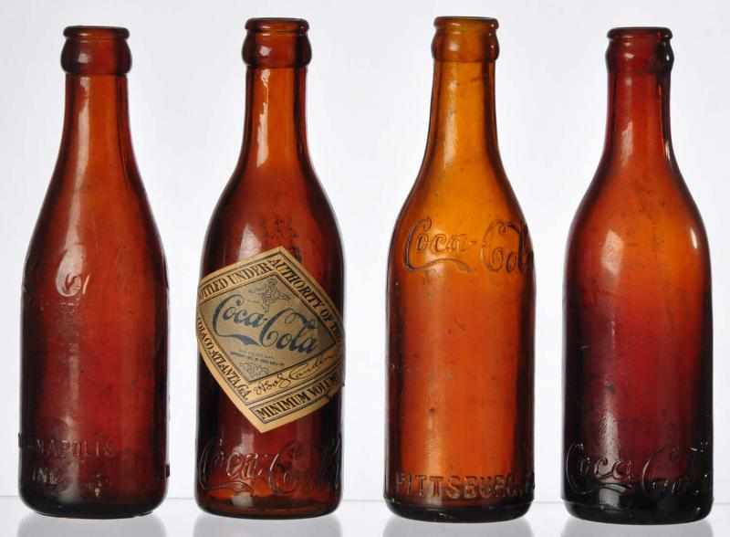 Appraisal: Lot of Amber Straight Sided Coca-Cola Bottles Description Includes Indianapolis