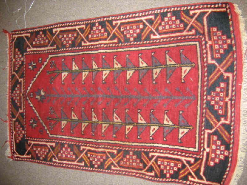 Appraisal: TURKISH PRAYER RUG The red field shows a directional geometric