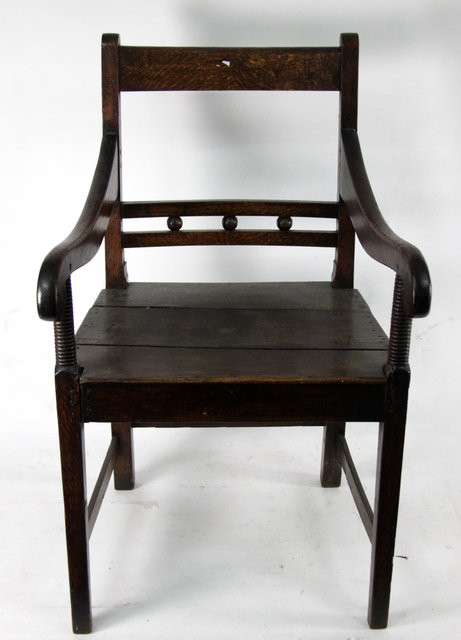 Appraisal: An early th Century oak and elm armchair with solid