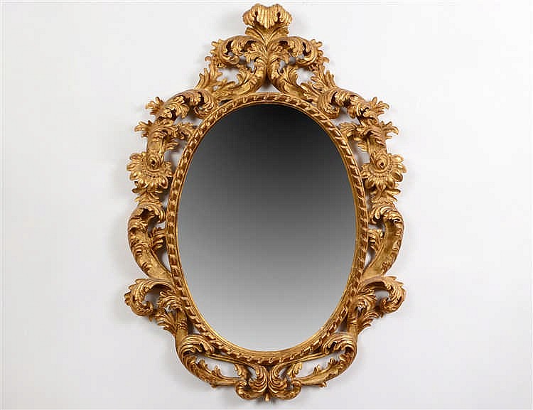 Appraisal: ROCOCO STYLE GILTWOOD OVAL MIRRORThe beveled mirror plate with a