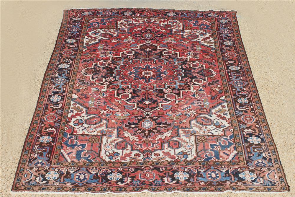 Appraisal: PERSIAN HERIZ WOOL RUG central medallion with corner brackets and