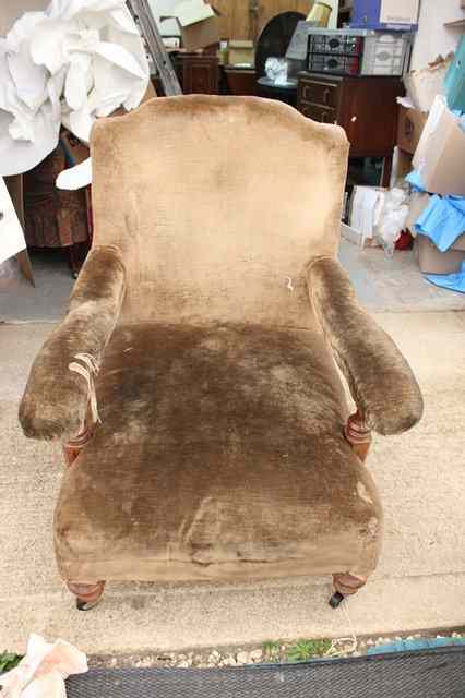 Appraisal: A LATE VICTORIAN BROWN DRAYLON ARMCHAIR with shaped upholstered back