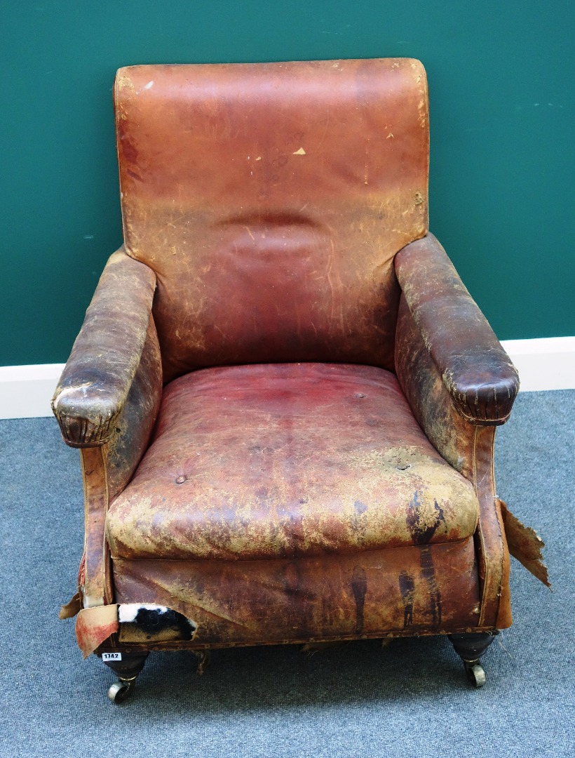 Appraisal: A Victorian leather and leatherette upholstered easy armchair on turned