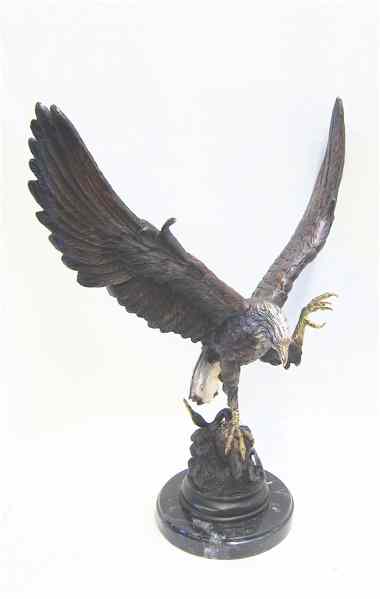 Appraisal: PATINATED BRONZE EAGLE SCULPTURE the eagle with wings spread grasping