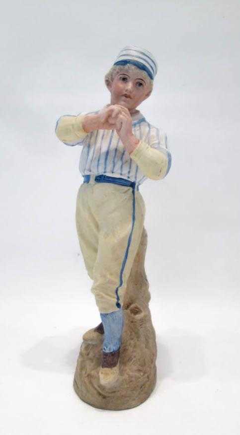 Appraisal: HEUBACH BISQUE BASEBALL FIGURE standing in a pitching pose impressed