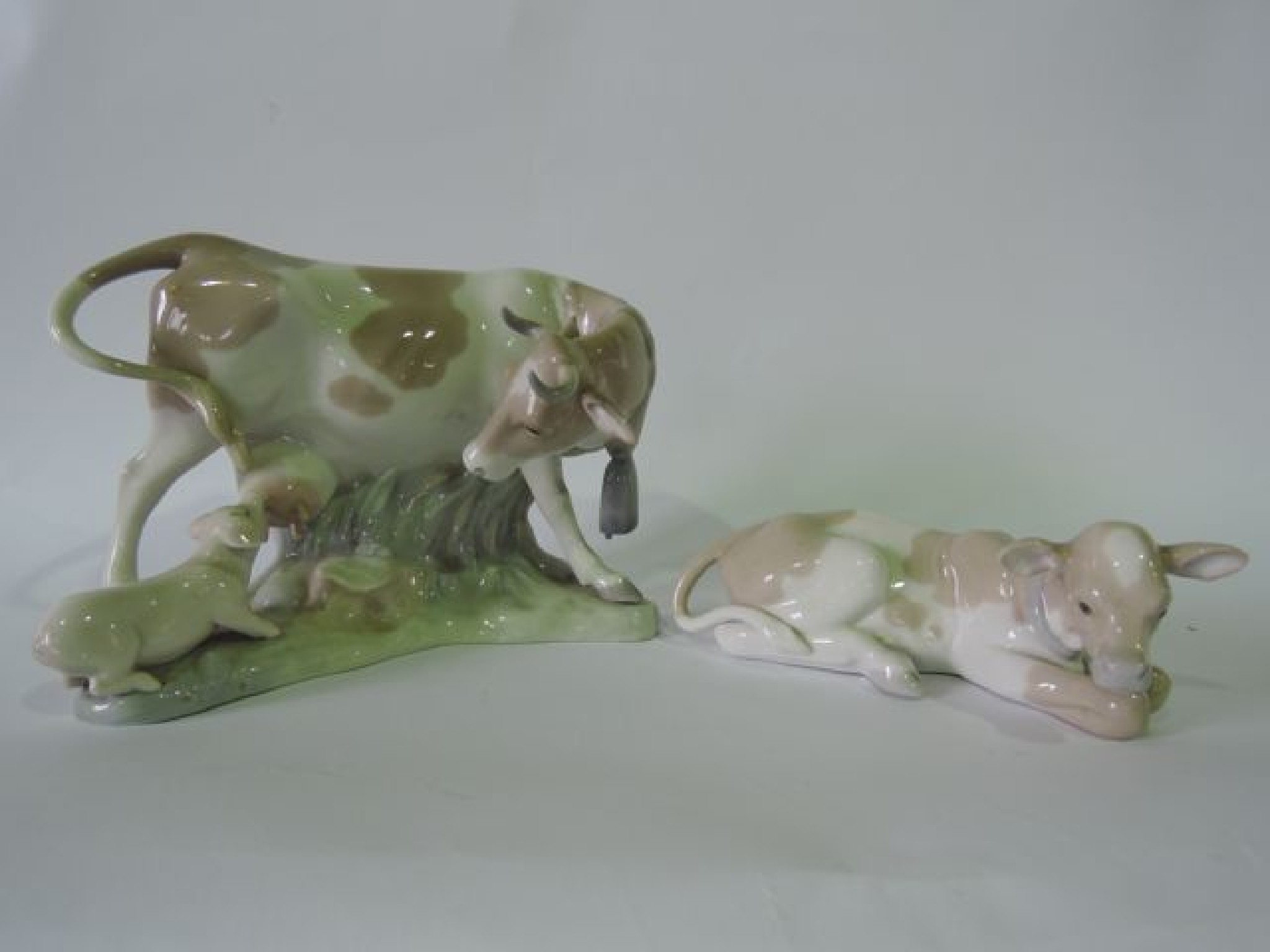 Appraisal: A Lladro group of a cow with suckling piglet together