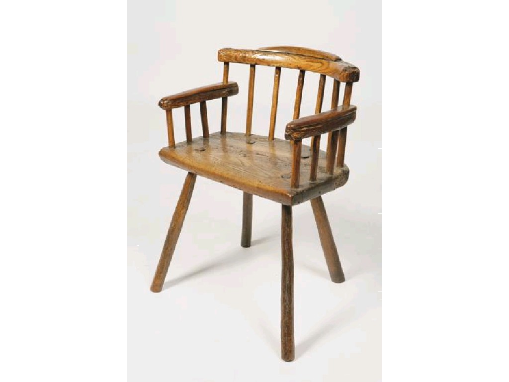 Appraisal: A PRIMITIVE WINDSOR ARMCHAIR with a solid straight fronted seat