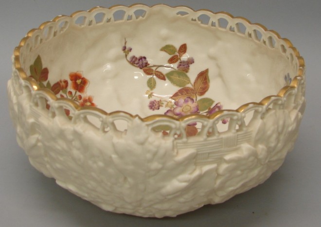 Appraisal: Interior of bowl features hand painted flowers gilt rim accent