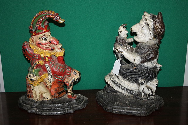 Appraisal: A CAST IRON PAIR OF DOOR STOPS in the form