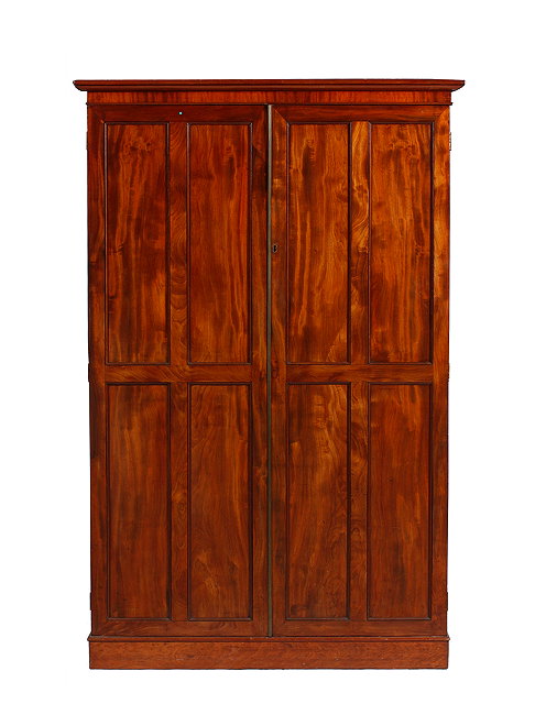 Appraisal: A WILLIAM IV MAHOGANY PRESS CUPBOARD the twin panelled doors