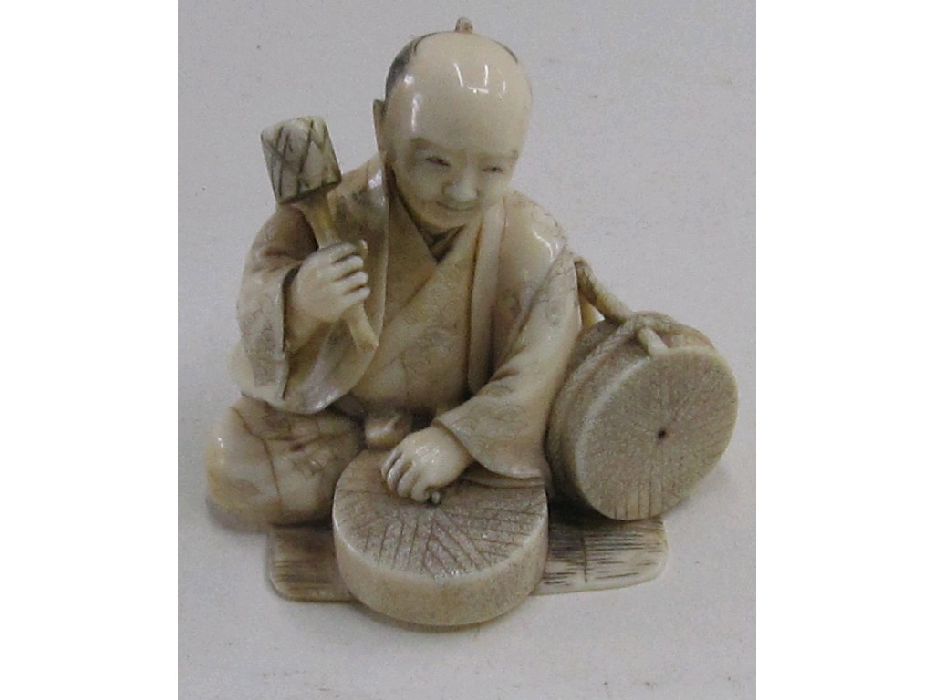 Appraisal: Japanese carved ivory figure - man using a mallet signed