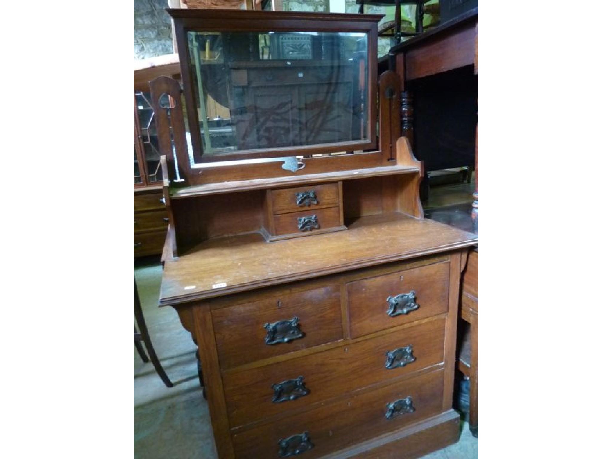 Appraisal: An Edwardian oak dressing chest in the Arts Crafts style