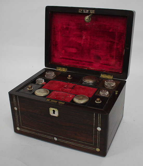 Appraisal: A VICTORIAN ROSEWOOD LADIES DRESSING BOX with pewter stringing and