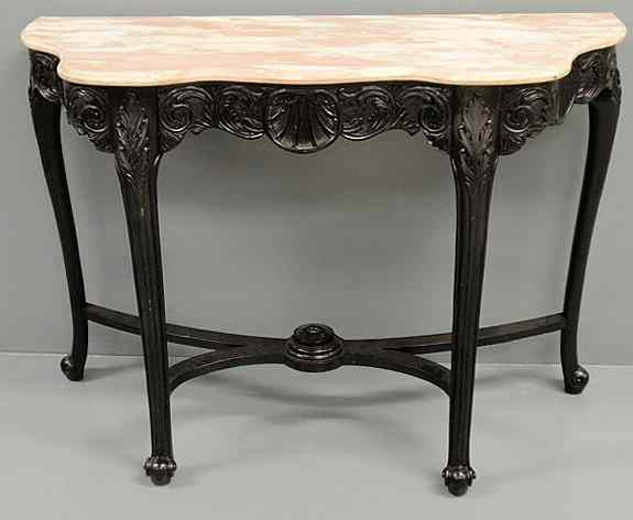 Appraisal: French carved and ebonized console table with a shaped colored